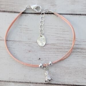 Claires Bracelet - Light Peachy Pink Tone with Charm